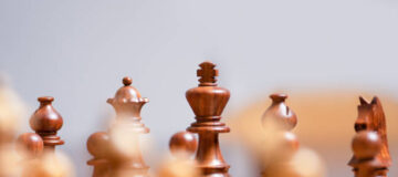 strategic chess game on wooden chess board